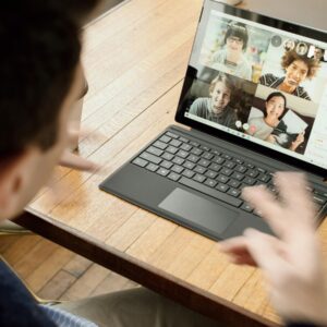 A learner on a group video call, practising spoken English with other students