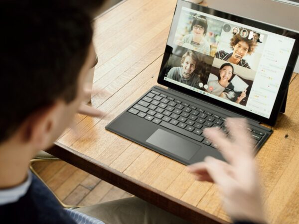 A learner on a group video call, practising spoken English with other students