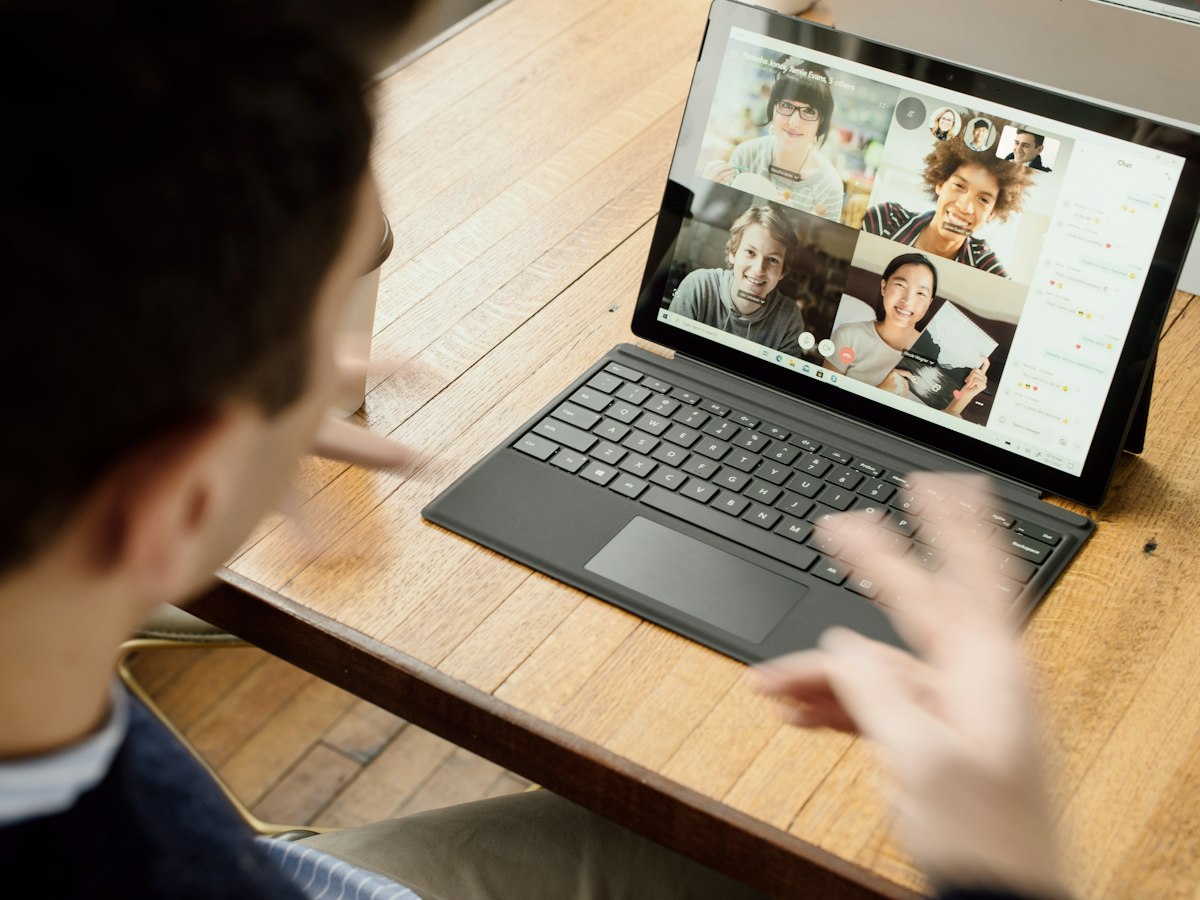 A learner on a group video call, practising spoken English with other students